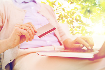 Image showing senior woman with laptop and credit card