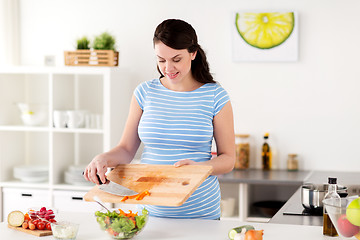 Image showing pregnant woman cooking vegetable salad at home