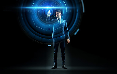 Image showing businessman in suit touching virtual projection