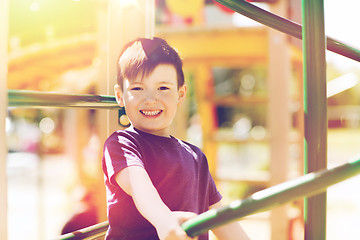 Image showing happy little boy climbing on children playground