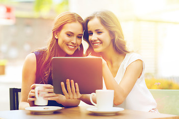 Image showing young women with tablet pc and coffee at cafe