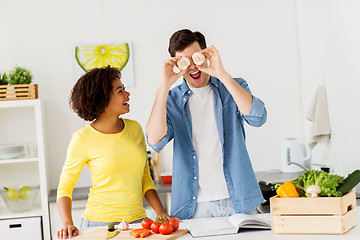 Image showing happy couple cooking food and having fun at home