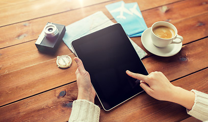 Image showing close up of traveler hands with tablet pc and map