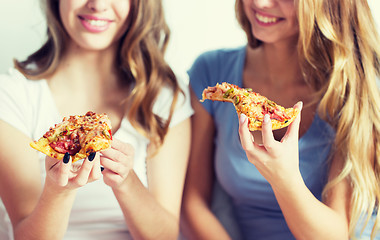 Image showing happy friends or teen girls eating pizza at home