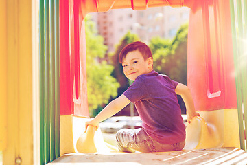 Image showing happy little boy on slide at children playground