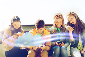 Image showing happy teenage friends with smartphones outdoors