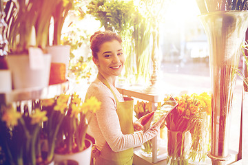 Image showing woman with tablet pc computer at flower shop