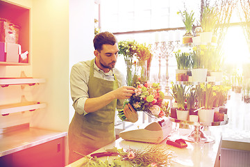 Image showing florist man making bunch at flower shop