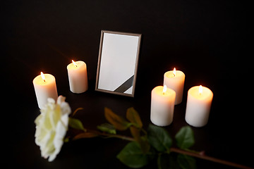 Image showing photo frame with black ribbon, flower and candles