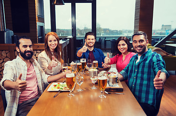 Image showing friends dining and drinking beer at restaurant