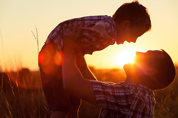 Image showing Father and son playing at the park at the sunset time.