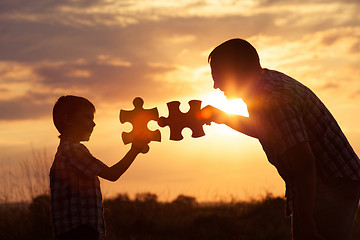 Image showing Father and son playing at the park at the sunset time.