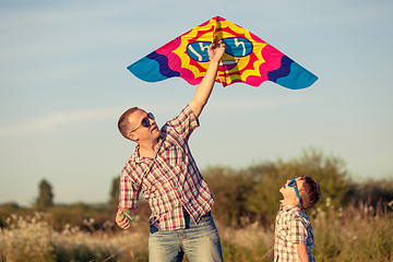 Image showing Father and son playing at the park at the sunset time.