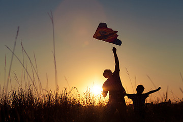 Image showing Father and son playing at the park at the sunset time.