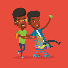 Image showing Two young friends riding by shopping trolley.