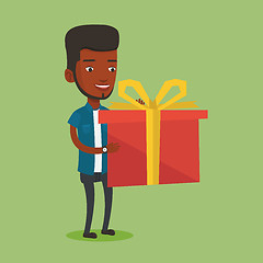 Image showing Joyful african-american man holding box with gift.