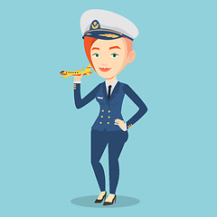 Image showing Cheerful airline pilot with model airplane.