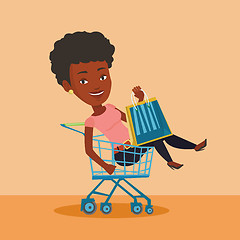 Image showing Happy woman riding by shopping trolley.