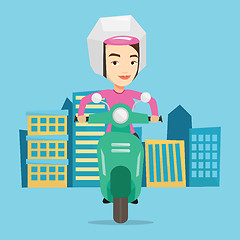 Image showing Woman riding scooter in the city.