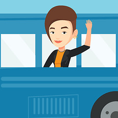 Image showing Woman waving hand from bus window.