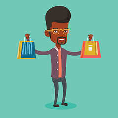 Image showing Happy man holding shopping bags.