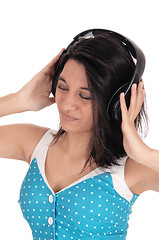 Image showing Woman listening to music with headphones.