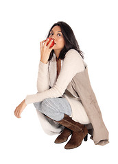 Image showing Woman eating red apple.