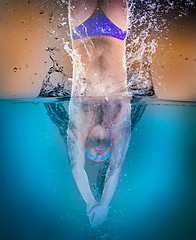 Image showing professional swimmer underwater after the jump