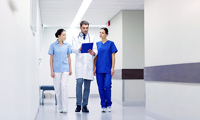 Image showing group of medics at hospital with clipboard