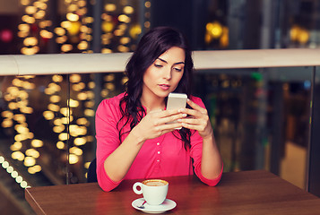 Image showing woman with smartphone and coffee at restaurant