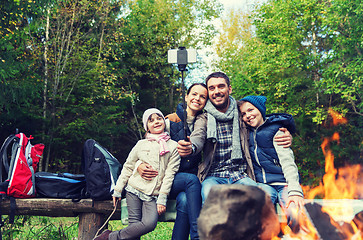 Image showing family with smartphone taking selfie near campfire