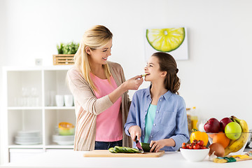 Image showing happy family cooking dinner at home kitchen