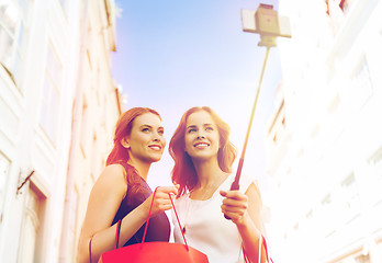 Image showing women shopping and taking selfie by smartphone