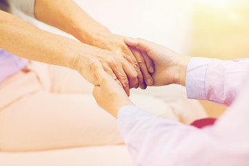 Image showing close up of senior and young woman hands