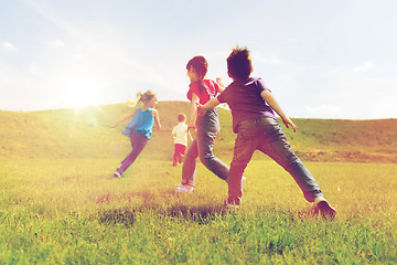 Image showing group of happy kids running outdoors