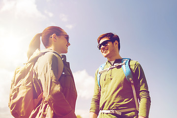 Image showing happy couple with backpacks hiking outdoors