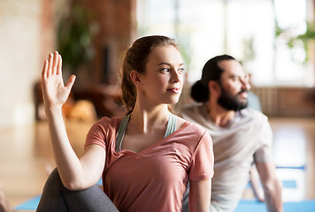 Image showing woman with group of people doing yoga at studio