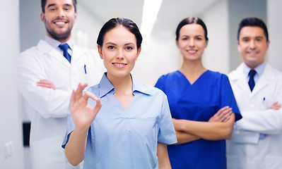 Image showing group of medics at hospital showing ok hand sign