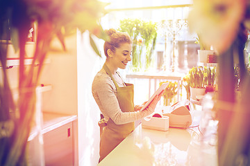 Image showing woman with tablet pc computer at flower shop