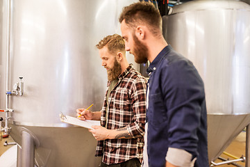 Image showing men with clipboard at craft brewery or beer plant