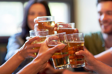 Image showing happy friends drinking beer at bar or pub