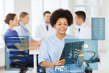 Image showing happy doctor with clipboard at hospital