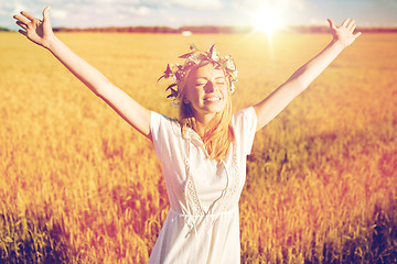 Image showing happy young woman in flower wreath on cereal field