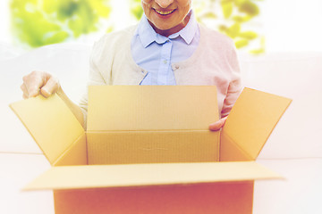 Image showing close up of senior woman with parcel box at home