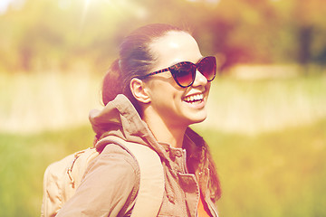 Image showing happy young woman with backpack hiking outdoors