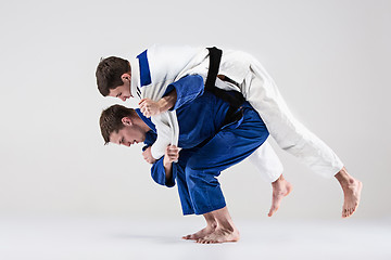 Image showing The two judokas fighters fighting men