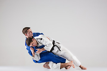 Image showing The two judokas fighters fighting men