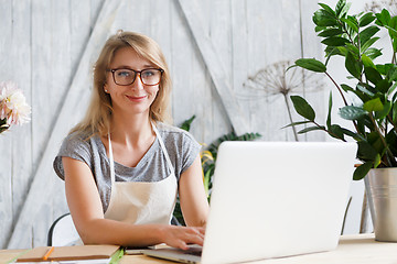 Image showing Woman florist sitting at table