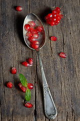 Image showing Ripe pomegranate and spoon 