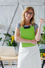 Image showing Smiling woman florist with glasses